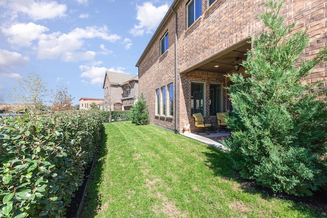 view of yard featuring a patio and ceiling fan