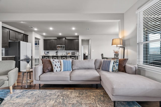 living room featuring visible vents, recessed lighting, and wood finished floors