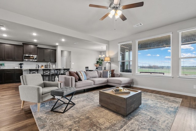 living area featuring visible vents, dark wood finished floors, recessed lighting, baseboards, and ceiling fan