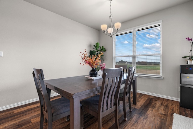 dining room with baseboards, an inviting chandelier, and wood finished floors