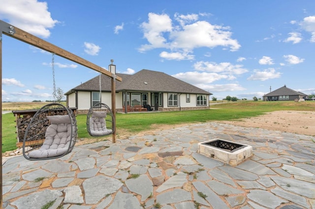 113 Misty Mountain Ln, Rhome, TX 76078 - back of house featuring a fire pit, a patio area, and a lawn
