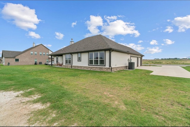 113 Misty Mountain Ln, Rhome, TX 76078 - rear view of property featuring central AC unit, concrete driveway, brick siding, a lawn, and an attached garage
