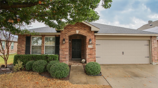 single story home with brick siding, concrete driveway, an attached garage, and a shingled roof