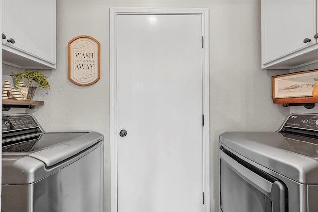 laundry room featuring cabinet space and washer and clothes dryer