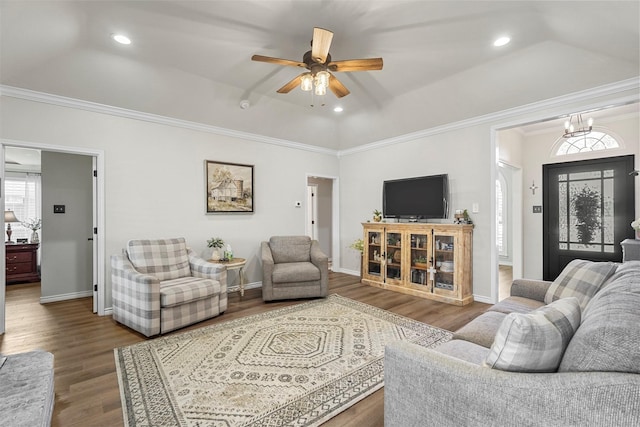 living room with crown molding, baseboards, recessed lighting, wood finished floors, and a raised ceiling