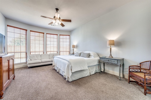 bedroom featuring baseboards, light carpet, visible vents, and a ceiling fan