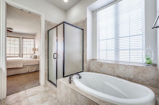 ensuite bathroom featuring tile patterned flooring, a shower stall, ensuite bath, and a garden tub