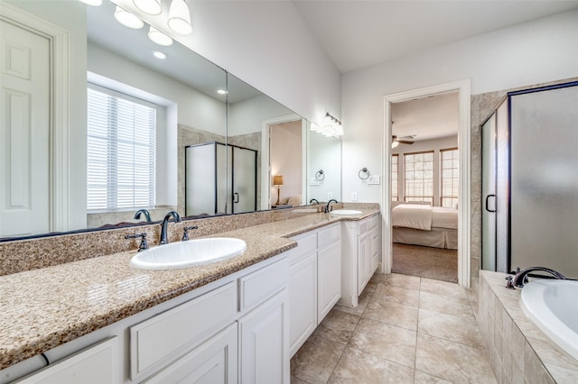 ensuite bathroom featuring a sink, a shower stall, ensuite bath, and double vanity