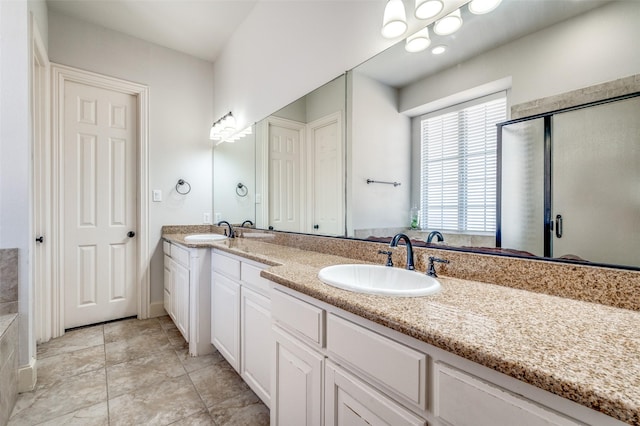 bathroom with a sink, double vanity, a bath, and a shower stall