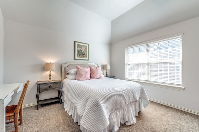 carpeted bedroom featuring lofted ceiling and baseboards