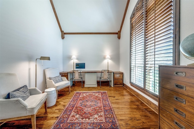 sitting room with high vaulted ceiling, crown molding, baseboards, and wood finished floors