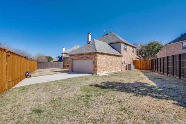 view of property exterior featuring central AC unit, driveway, a chimney, a garage, and brick siding