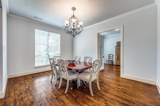 dining area featuring an inviting chandelier, crown molding, dark wood-style floors, and visible vents