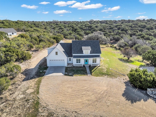 bird's eye view featuring a wooded view