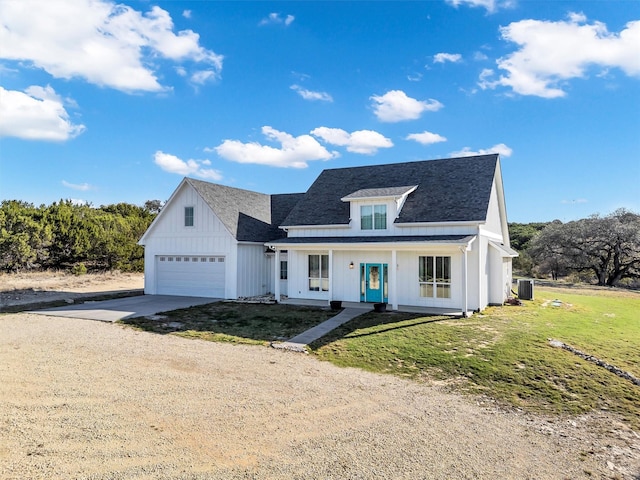 modern inspired farmhouse featuring a front lawn, driveway, a shingled roof, a garage, and central AC unit