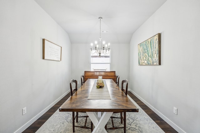 dining room with vaulted ceiling, a notable chandelier, dark wood-style floors, and baseboards