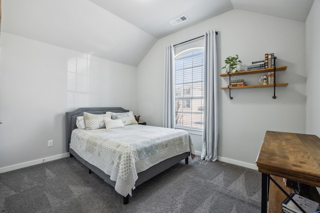 bedroom featuring dark colored carpet, visible vents, baseboards, and vaulted ceiling