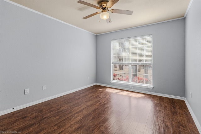 empty room featuring ceiling fan, baseboards, wood finished floors, and crown molding