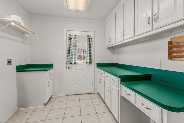 kitchen with light tile patterned floors, white cabinetry, and dark countertops