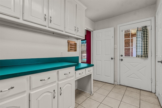 kitchen featuring white cabinetry, dark countertops, and light tile patterned flooring