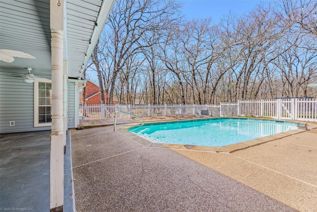 view of swimming pool with a fenced backyard, a fenced in pool, ceiling fan, and a patio area