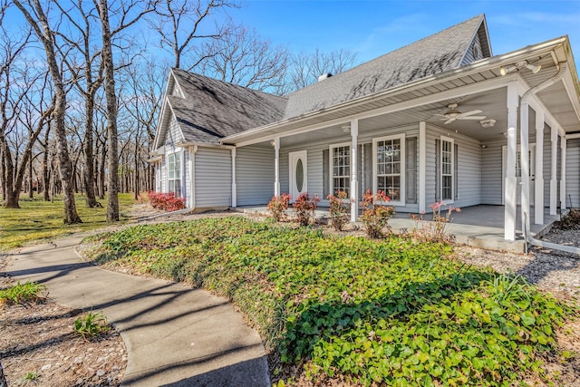 view of front of property with a porch, ceiling fan, and a shingled roof