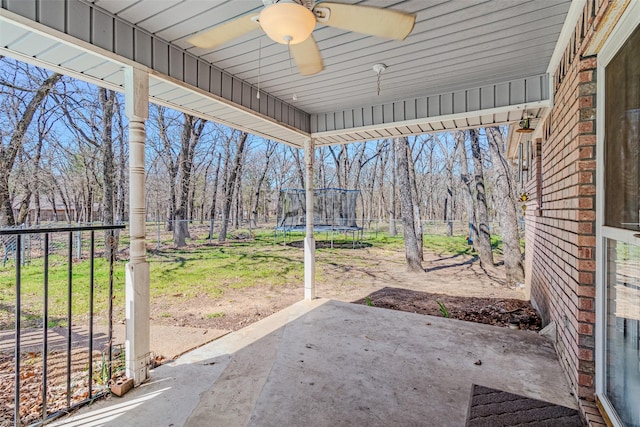 view of patio featuring a fenced backyard, a ceiling fan, and a trampoline