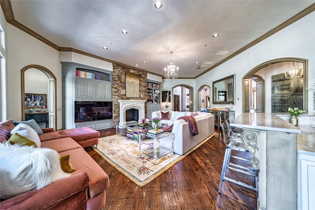 living room with a large fireplace, a chandelier, recessed lighting, arched walkways, and dark wood-style flooring