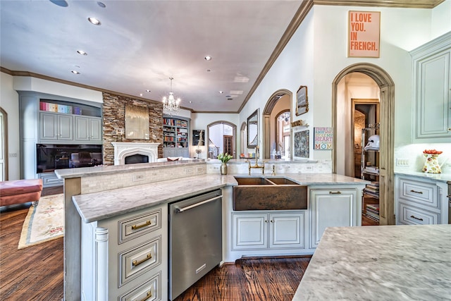 kitchen featuring arched walkways, open floor plan, dark wood-style flooring, and stainless steel dishwasher