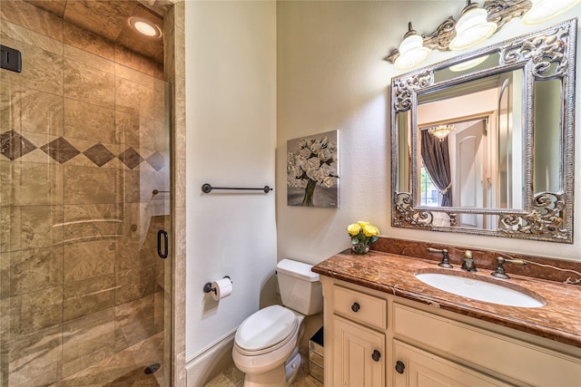 full bathroom with a shower stall, toilet, vanity, and baseboards