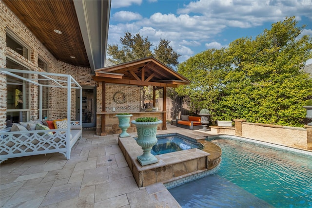 view of pool with outdoor lounge area, a patio, fence, and a pool with connected hot tub