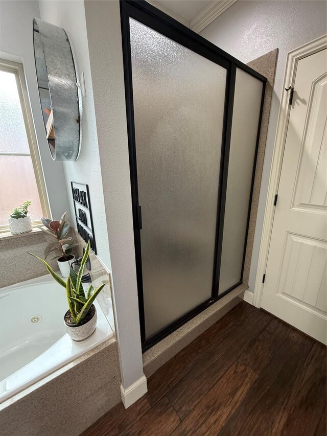 bathroom featuring a shower stall and crown molding