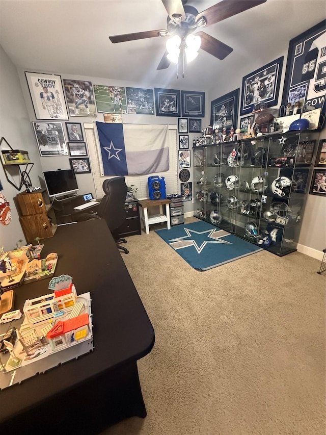 carpeted home office featuring ceiling fan