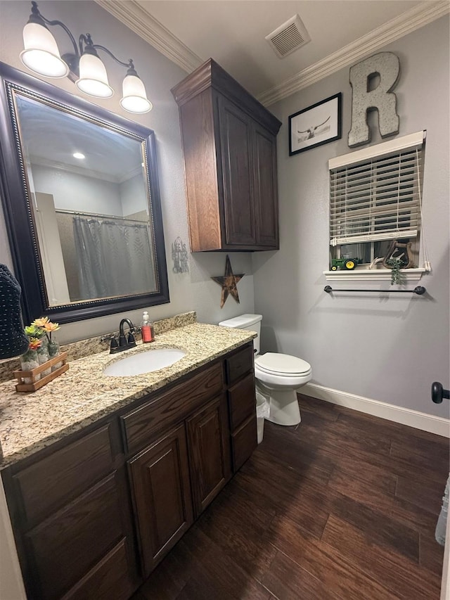 full bathroom featuring visible vents, baseboards, toilet, ornamental molding, and wood finished floors