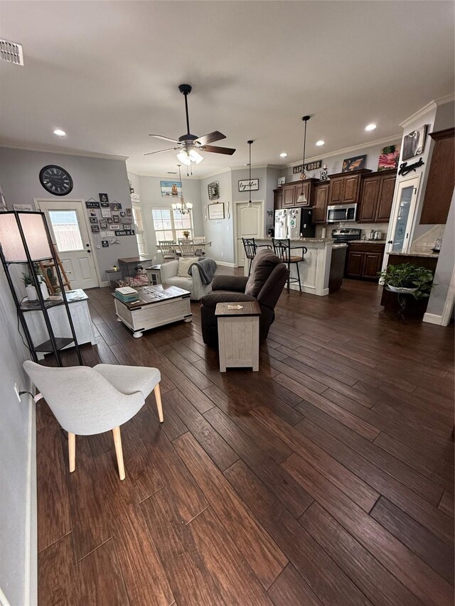 living area featuring dark wood-style floors, visible vents, recessed lighting, and crown molding