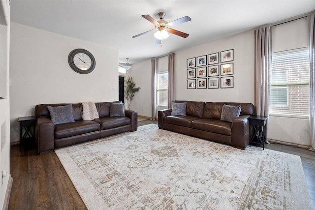 living area featuring ceiling fan, baseboards, and wood finished floors