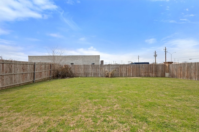 view of yard with a fenced backyard