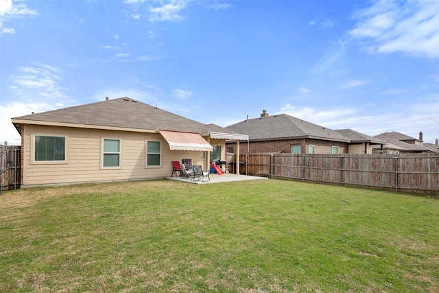 back of house with a yard, a fenced backyard, and a patio area