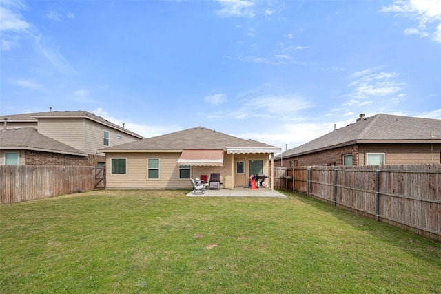 back of house featuring a fenced backyard, a yard, and a patio