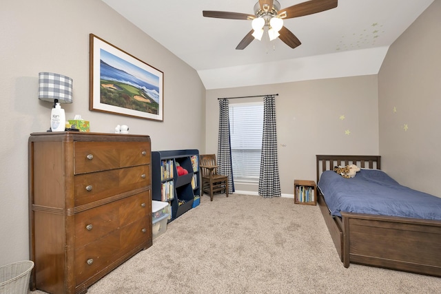 carpeted bedroom featuring baseboards, lofted ceiling, and a ceiling fan