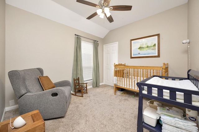 carpeted bedroom with lofted ceiling, a ceiling fan, and baseboards