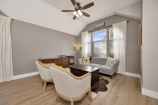 living room featuring ceiling fan, baseboards, light wood-type flooring, and lofted ceiling