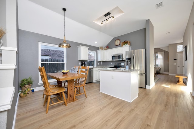 kitchen with light wood finished floors, visible vents, appliances with stainless steel finishes, and a kitchen island