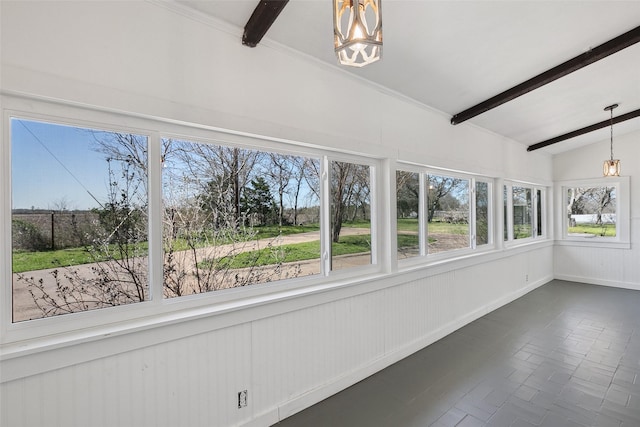 unfurnished sunroom featuring an inviting chandelier, lofted ceiling with beams, and plenty of natural light