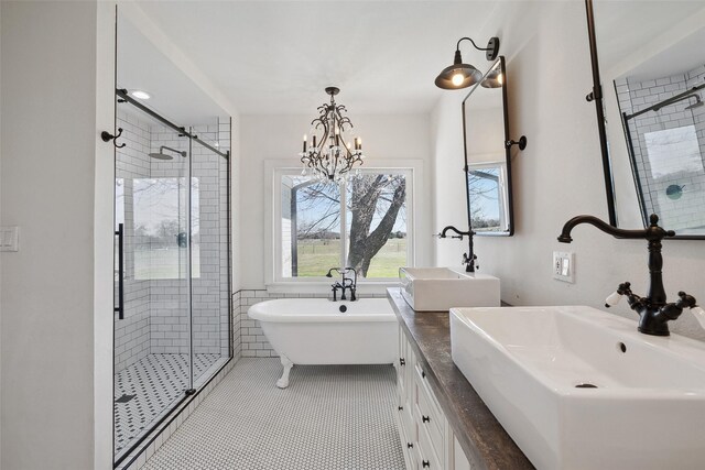 full bathroom with tile patterned flooring, a shower stall, and a sink