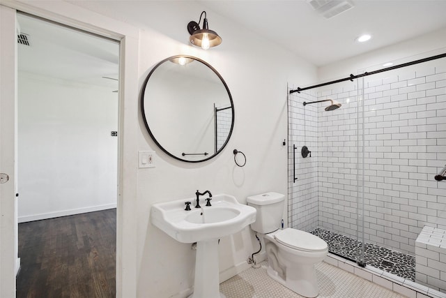 bathroom featuring visible vents, baseboards, toilet, recessed lighting, and a stall shower