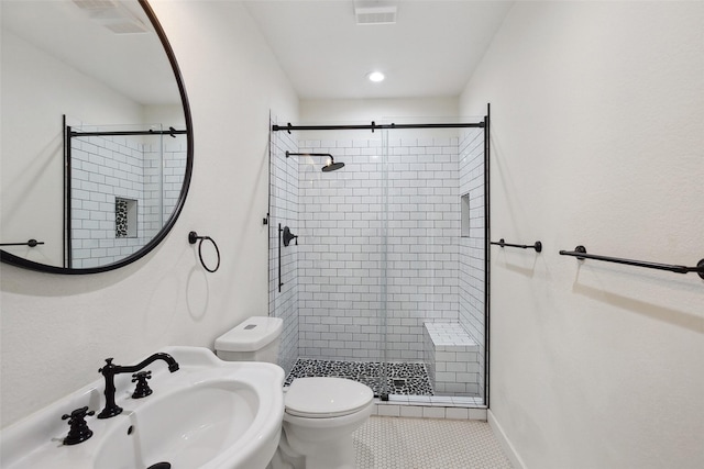 bathroom with a sink, visible vents, toilet, and a stall shower