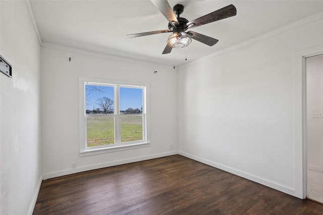 empty room featuring baseboards, dark wood-type flooring, a ceiling fan, and crown molding