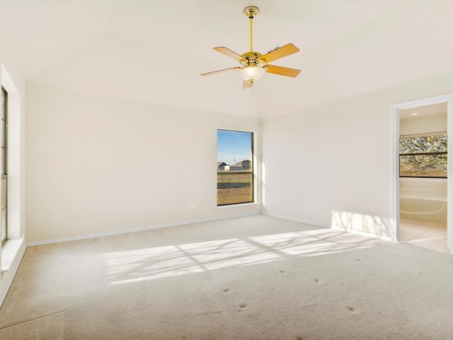 carpeted spare room with baseboards and ceiling fan