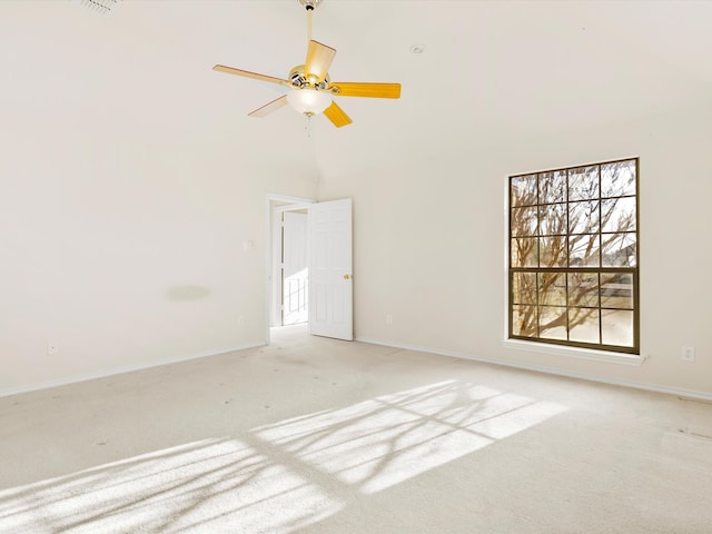 spare room with a ceiling fan, baseboards, and carpet floors